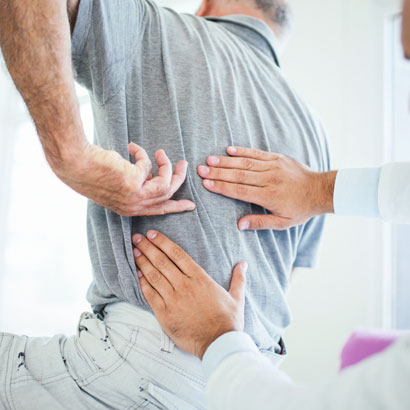 doctor-examining-patient's-back