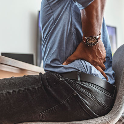 man-with-back-pain-in-desk-chair